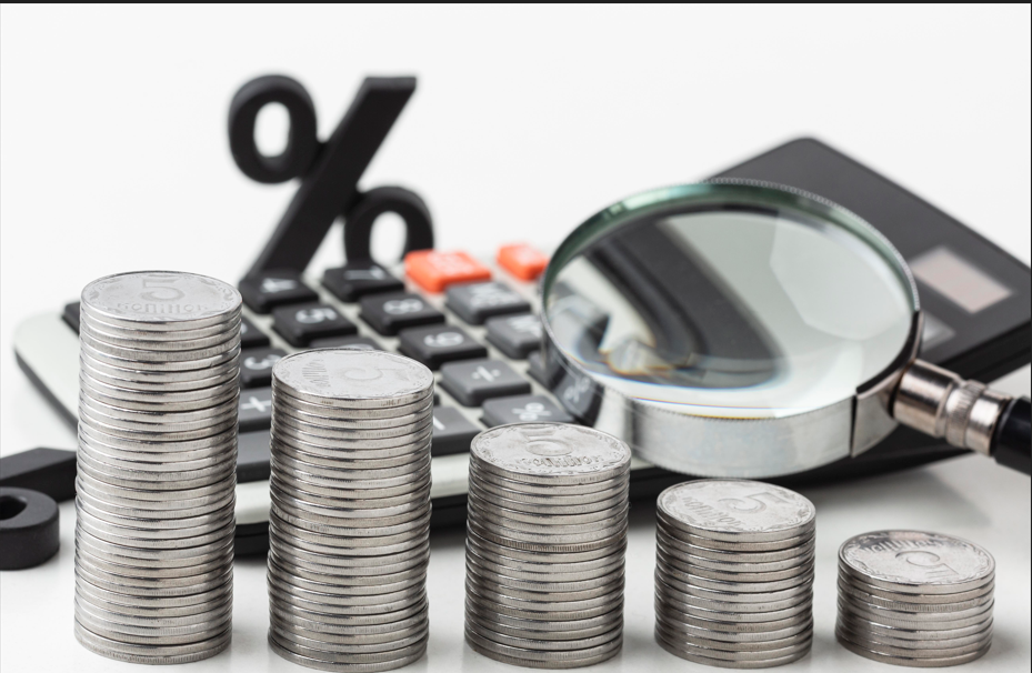 Business professionals reviewing Value Added Tax (VAT) documents in UAE office with financial reports and calculator on desk